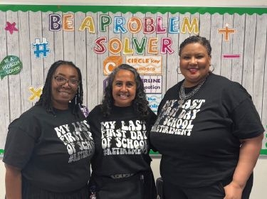 three teachers wearing black t shirts